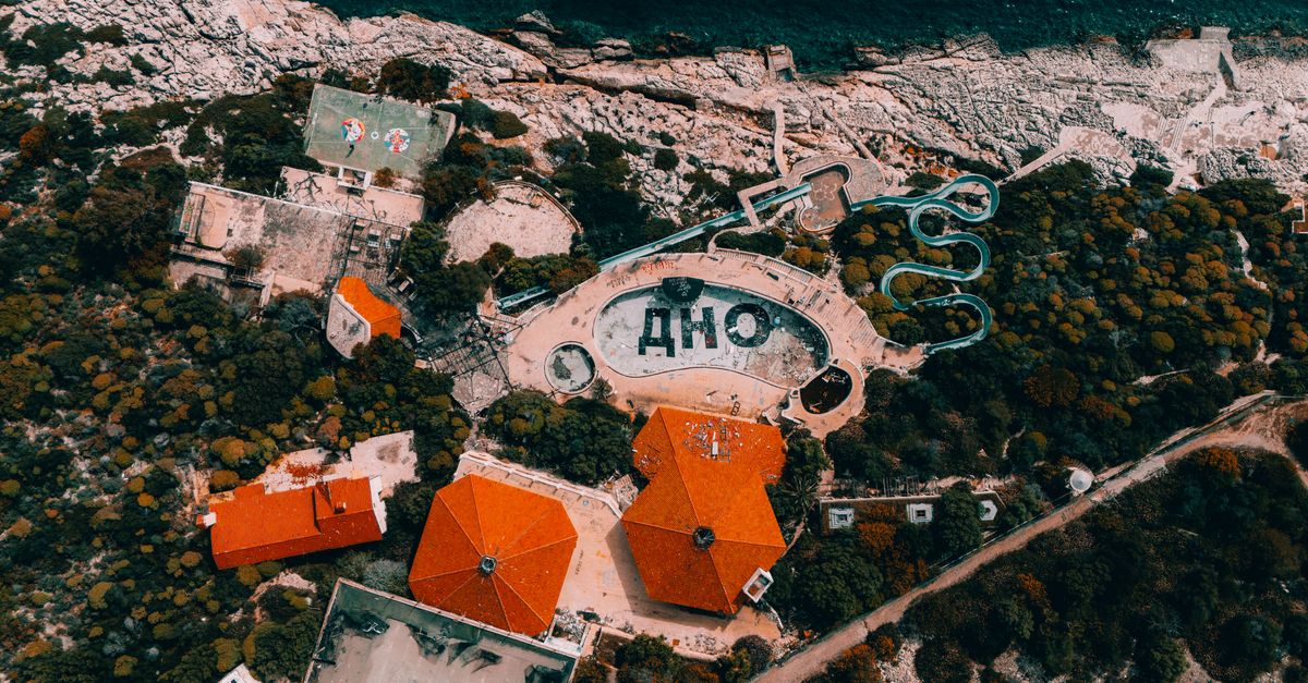 Aerial photo showing an abandoned water park on Antalya's coast with unique structures and vivid colors.
